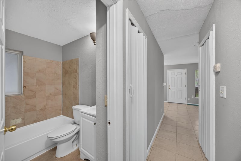 Bathroom with toilet, sink and hallway view at 4030 Leonard Cir W, Jacksonville, FL 32209