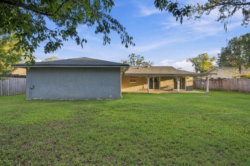 Backyard exterior view toward the home, photographed by Megapixeler on Crosby Ln, Orange Park