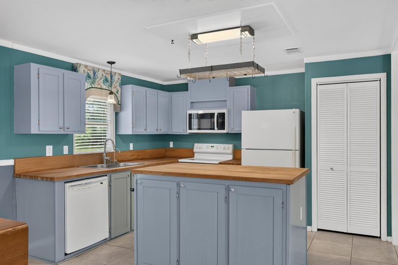 Kitchen cabinets with microwave and refrigerator at 2549 Snapdragon Ave, Middleburg, FL 32068