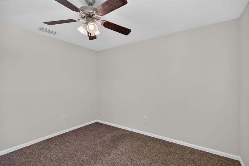 Bedroom with ceiling fan and carpet at 6830 Hanford St, Jacksonville, FL 32219