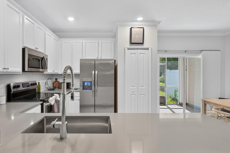 Kitchen sink with view toward the stairs at 1186 Beach Dune Dr, Jacksonville, FL 32233