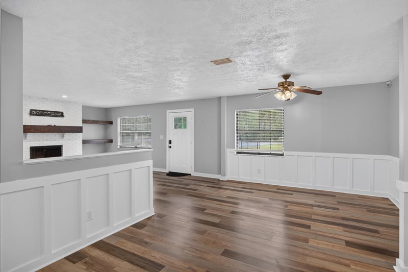 Living area with built-in shelving and wainscoting at 6757 Deer Springs Rd, Keystone Heights, FL 32656