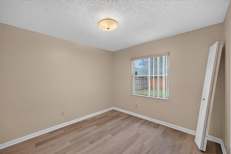 Bedroom with window and wood-look floors at 6646 Shiloh Creek Dr