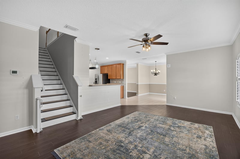 Staircase with wood floors and area rug at 1493 Greyfield Dr, St. Augustine, FL 32092