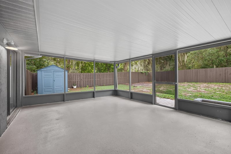 Screened porch with view of yard and shed at 551 Deltona Blvd, St. Augustine, FL 32086