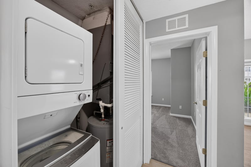 Laundry closet with stacked washer and dryer at 575 Oakleaf Plantation Pkwy, Orange Park, FL 32065