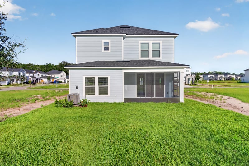 Rear exterior with screened lanai and open lawn at 269 Bluegrass Wy, St. Augustine, FL 32092
