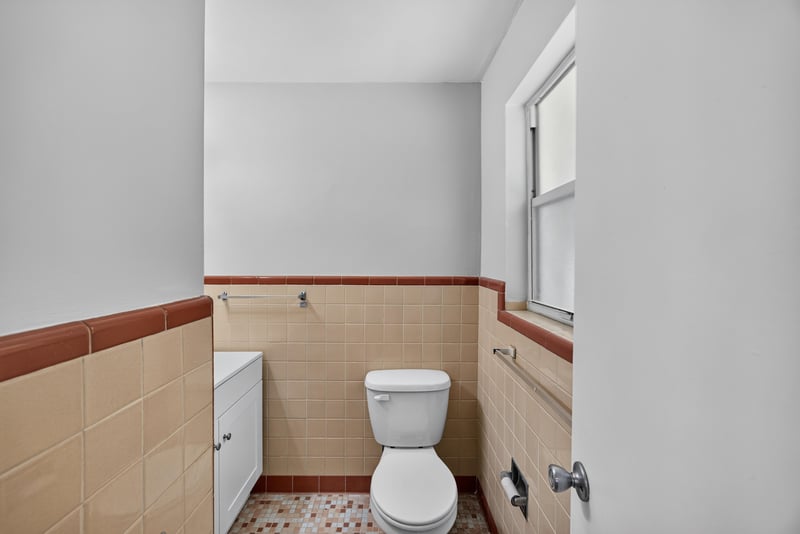 Bathroom with peach tile and window at 5527 Beney Rd, Jacksonville, FL 32207