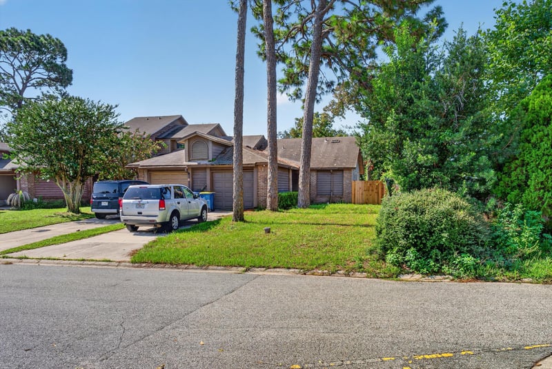Street view of the home and neighboring houses at 8010 International Village Dr, Jacksonville, FL 32277