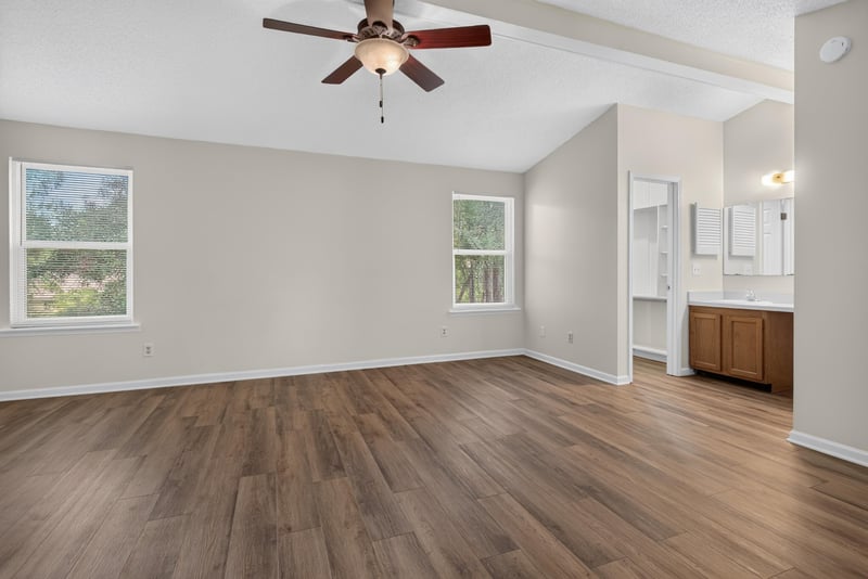 Empty room with vaulted ceiling and windows at 4427 Millstone Ct, Jacksonville, FL