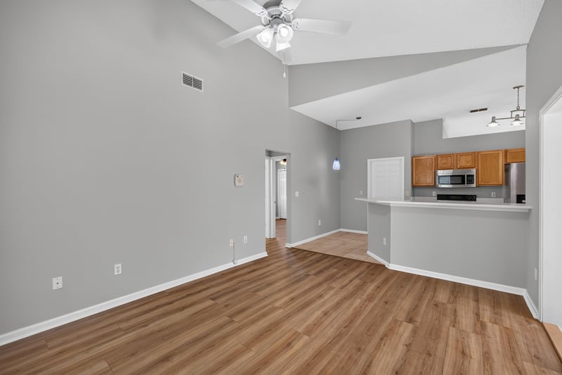 Living room open to kitchen with vaulted ceiling at 9256 Dale View Ln W, Jacksonville, FL 32225