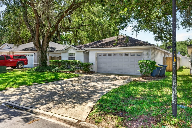 Front exterior with driveway and oak canopy at 1108 Hidden Cove Cir S, Atlantic Beach, FL 32233