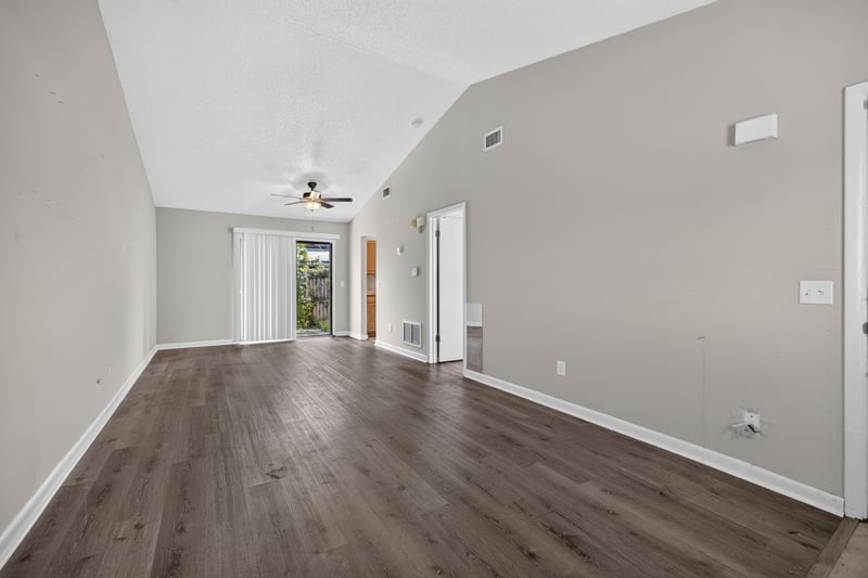 Living room corner with ceiling fan and window at 2719 Trollie Ln