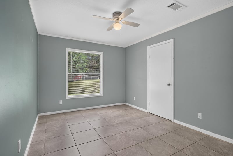 Empty bedroom with gray walls and window at 2549 Snapdragon Ave, Middleburg, FL 32068
