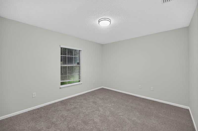 Empty carpeted room with window at 706 Bonaparte Dr, Jacksonville, FL 32218