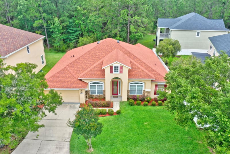 Front exterior with tile roof and landscaped yard at 635 Wakeview Dr, Orange Park, FL 32065