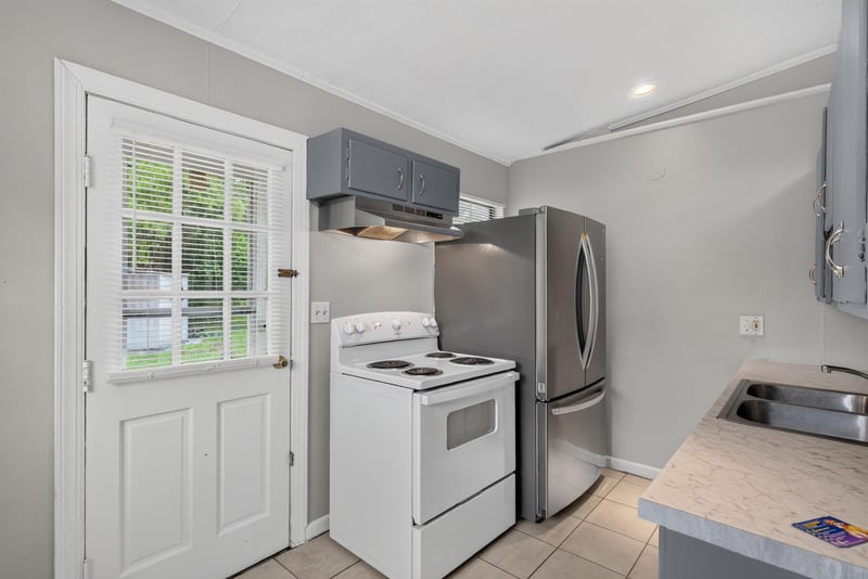 Kitchen with stainless refrigerator and white stove at 255 Woodside Dr, Orange Park, FL 32073