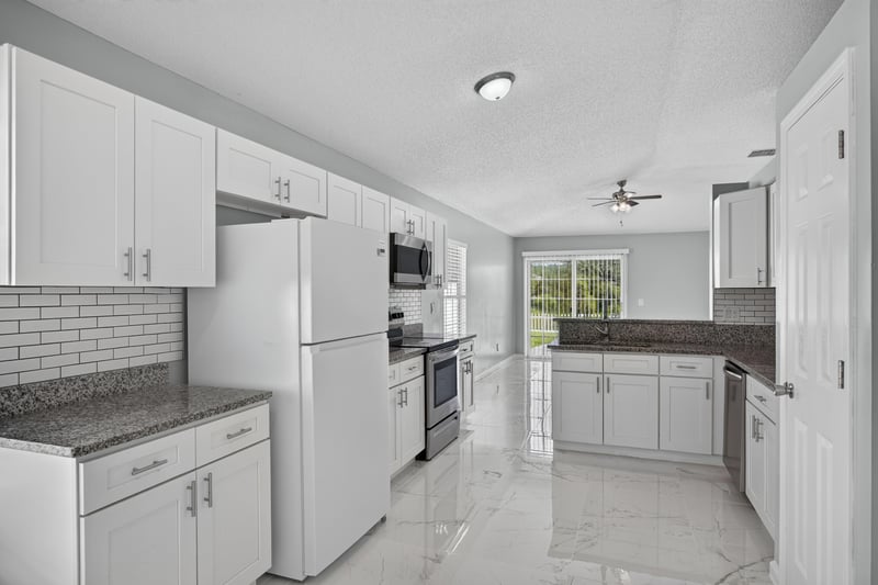 Kitchen with stainless appliances and subway tile backsplash at 490 Hillside Dr, Orange Park, FL 32073
