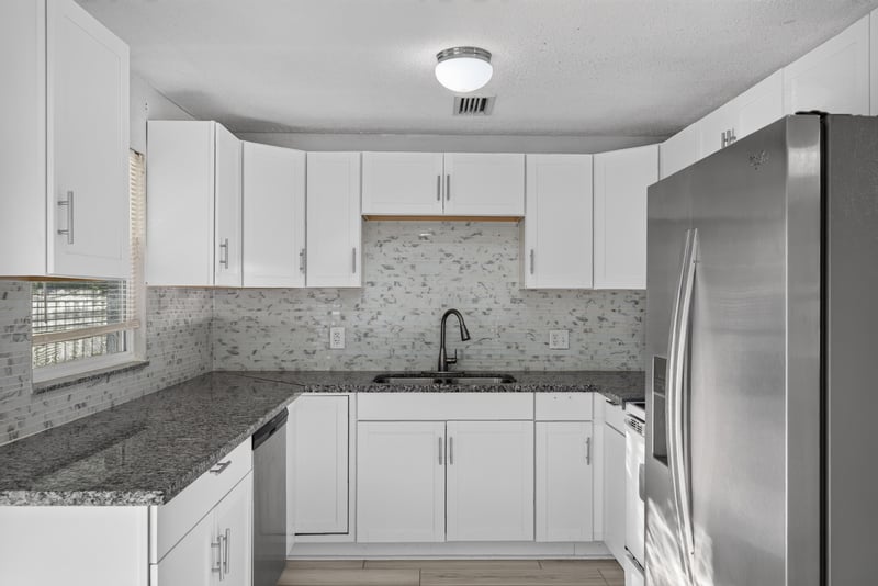 Kitchen with white cabinets and stainless refrigerator at 442 Ameca Ave, Orange Park, FL 32073