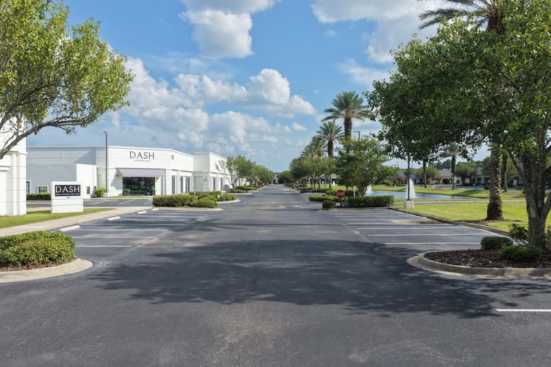 Palm-lined street approaching the DASH building at 10550 Deerwood Park Blvd, Jacksonville, FL 32256