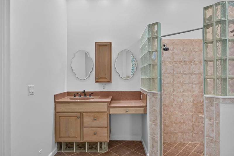 Primary bath double vanity and glass block window at 11675 Magnolia Estates Rd, Jacksonville, FL 32223
