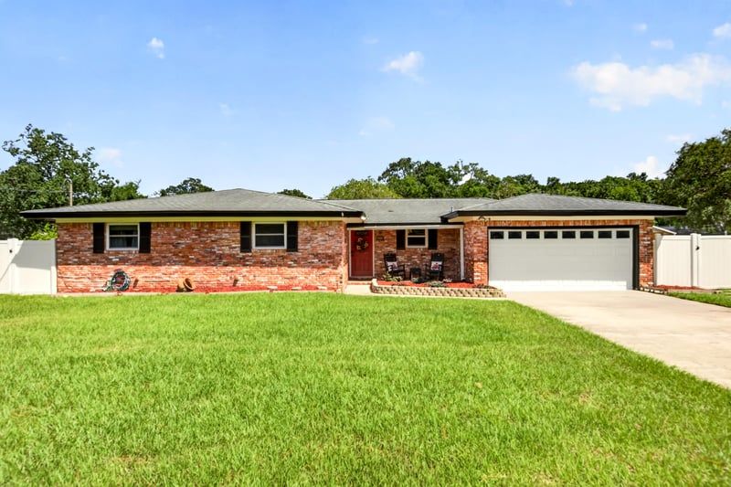 Front exterior with lawn and brick facade at 6059 Karen St, Jacksonville, FL 32244