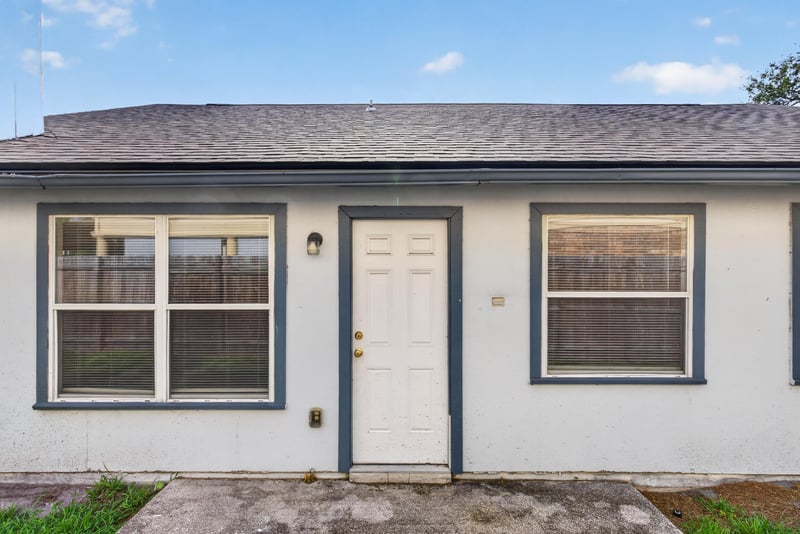 Rear exterior with dark-trimmed door and windows at 400 Ashcroft Landing Dr, Jacksonville, FL 32225