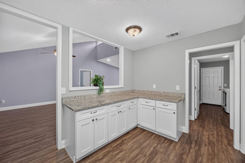 Kitchen pass-through with wood floor hallway at 12344 Cormorant Ct, Jacksonville, FL