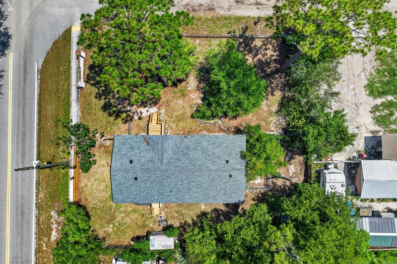 Aerial straight-down view of roof and trees at 7603 Coach Park Dr, Jacksonville, FL 32244