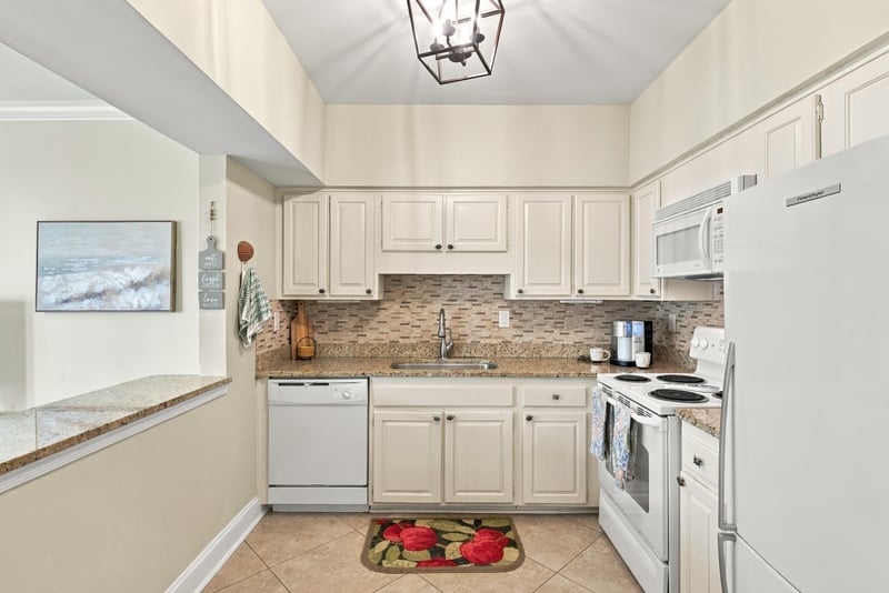 Kitchen with white cabinets and granite counters at 805 Spinnakers Reach Dr, Ponte Vedra Beach, FL 32082