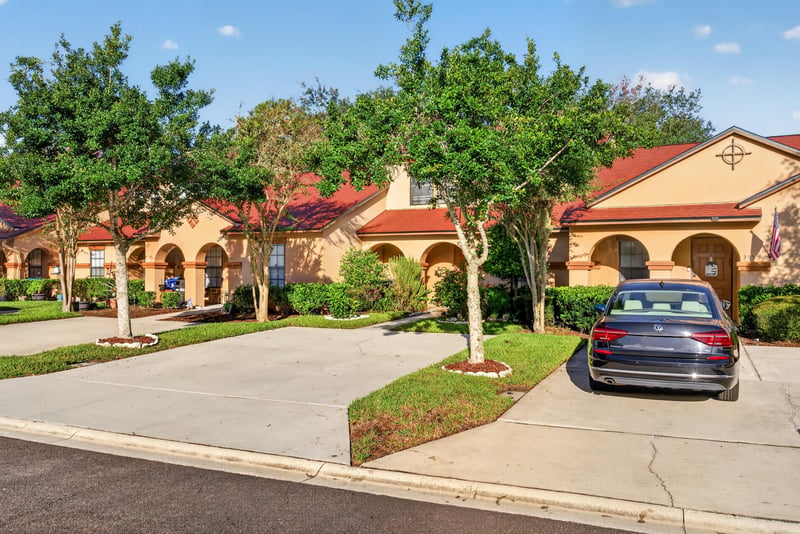 Entry courtyard with covered walkways and parking at 353 Redwood Ln