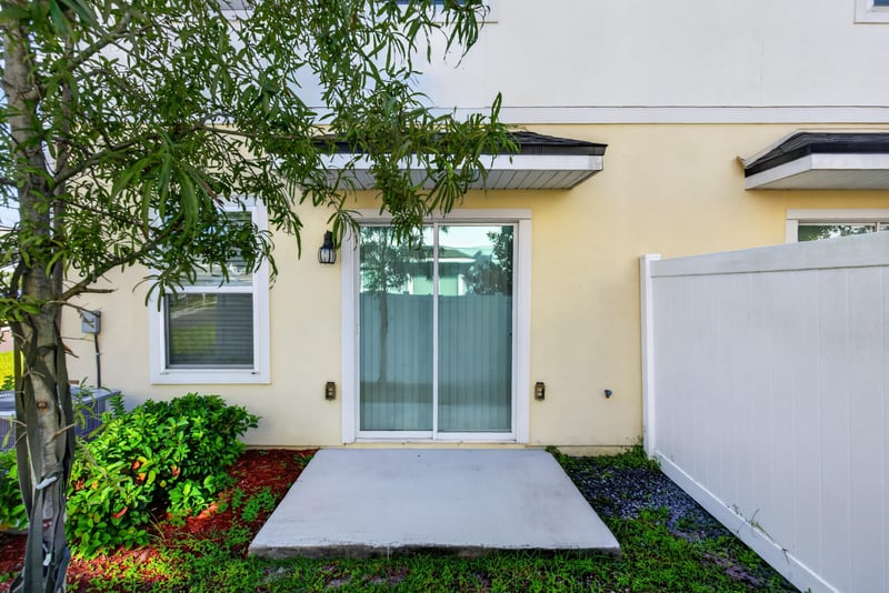 Side patio with paved area and landscaping at 4024 Bay Hawk Ct, Jacksonville, FL