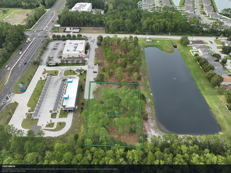 Aerial view of the building, parking lot, and pond at 4900 US-1, St. Augustine, FL 32086