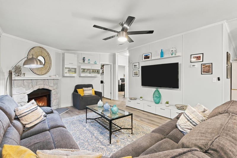 Living room with fireplace and TV, photographed by Megapixeler on Secret Cove Rd, Middleburg, FL