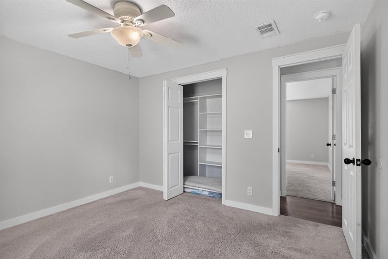 Bedroom with carpet and double closet doors at 4890 McAllister Rd, Middleburg, FL 32068