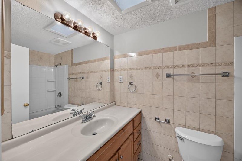 Bathroom vanity with tile shower surround at 1435 Undine Ave, Jacksonville, FL