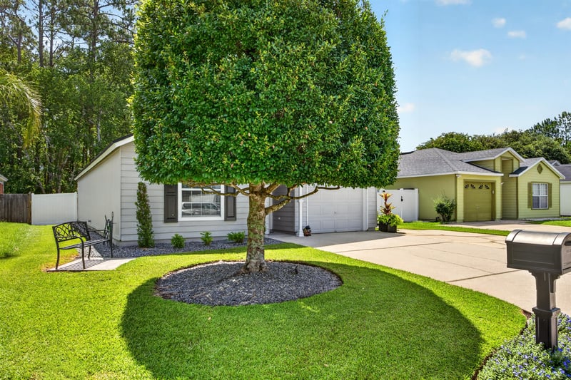 Drone view of front yard tree and street in Middleburg, FL