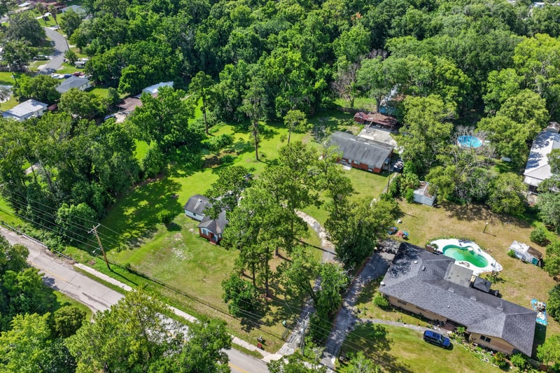 Aerial view of the neighborhood and surrounding lots at 5745 110th St, Jacksonville, FL 32244
