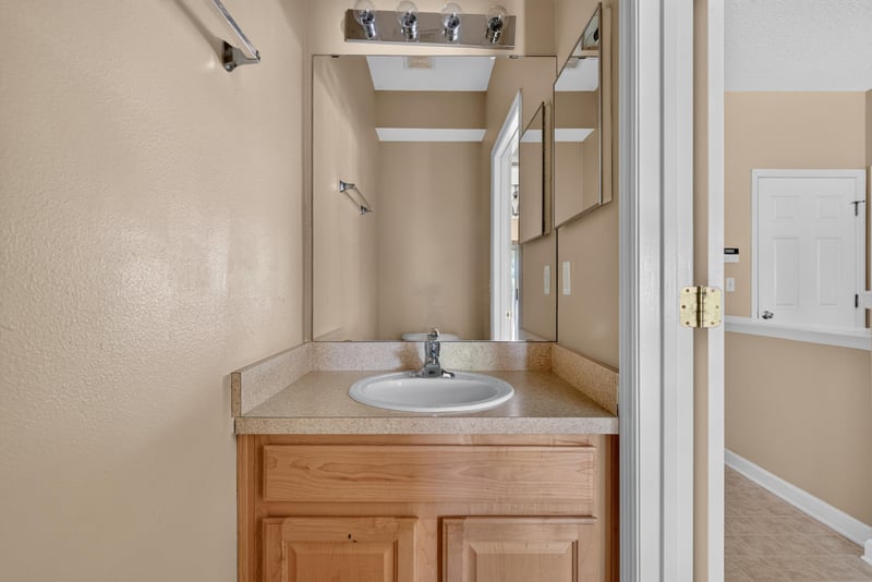 Bathroom vanity with mirror at 12359 Mangrove Forest Ct, Jacksonville, FL 32218