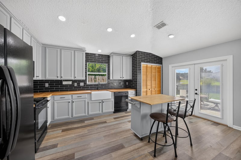 Kitchen with gray cabinets and island at 2065 Creekmont Dr