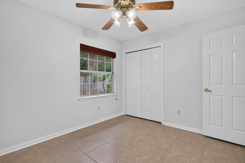 Bedroom with closet and tile floor at 12810 Swamp Owl Ln