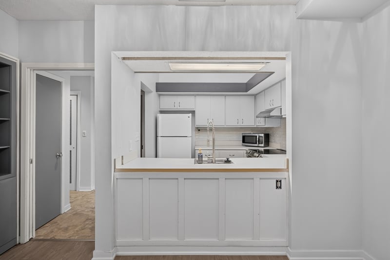 Kitchen pass-through window with built-in shelving at 2910 Ravines Rd, Middleburg, FL 32068