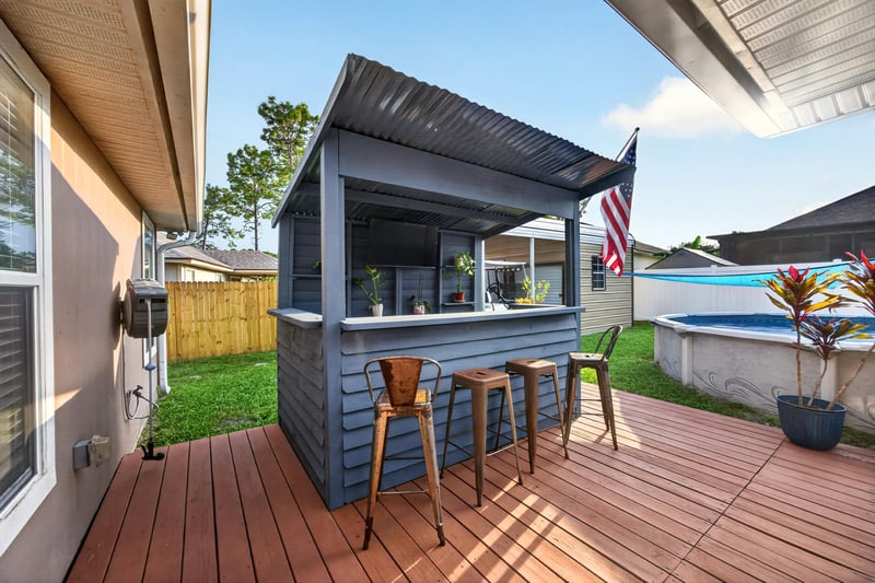 Covered patio bar with pergola and stools at 3112 Silverado Cir, Green Cove Springs, FL 32043