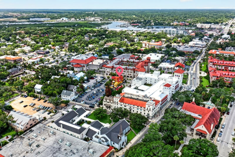 Aerial view of the city and surrounding tree canopy in St. Augustine, FL