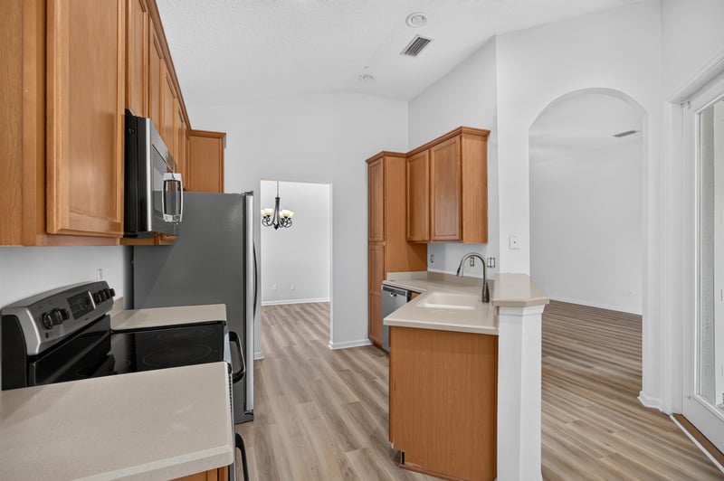 Kitchen view toward range and wood cabinets at 3101 E Banister Rd, St. Augustine, FL 32092