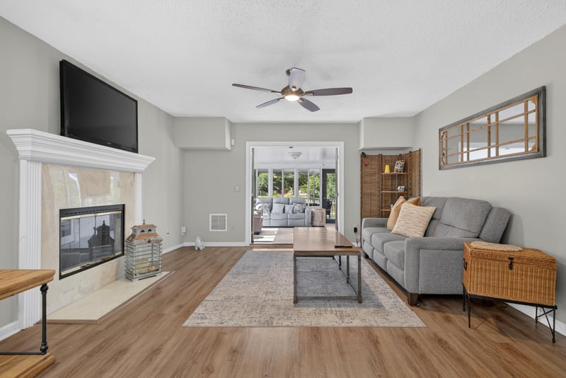 Living room with fireplace and sliding doors at 8680 Bandera Cir S, Jacksonville, FL 32244