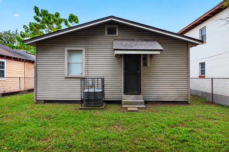 Rear exterior with AC unit and white siding at 1473 State St W, Jacksonville, FL 32209
