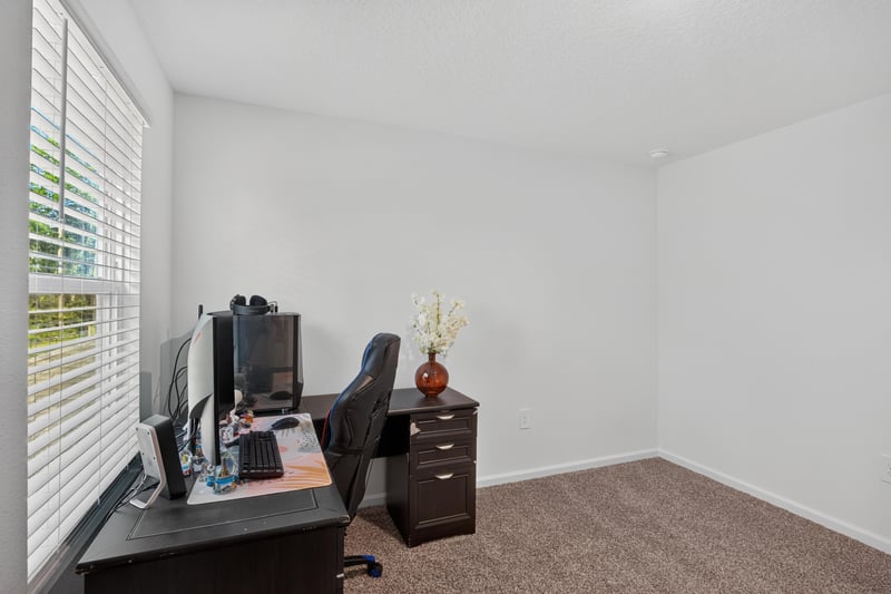 Bedroom with desk and dresser at 65255 Frst Glen Ln, Yulee, FL 32097