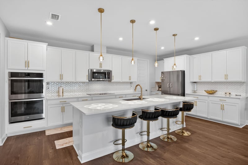 Kitchen island with bar seating and pendant lights at 85491 Fall River Pkwy, Fernandina Beach, FL 32034