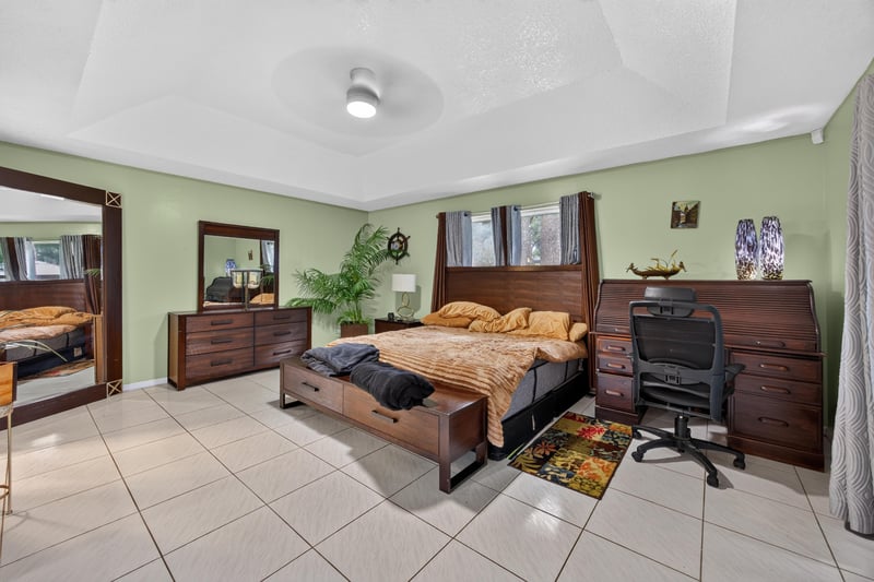 Primary bedroom with dark wood furniture at 1346 Gately Ct, Jacksonville, FL 32225